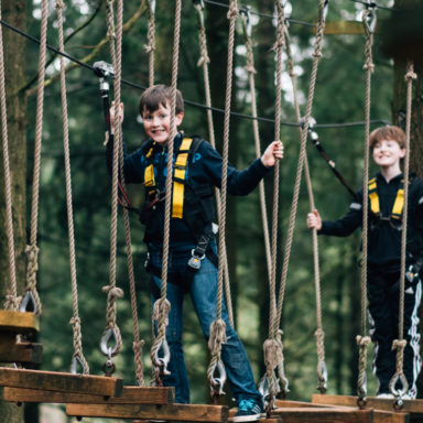 Kids TTA   2 kids smiling on ropes